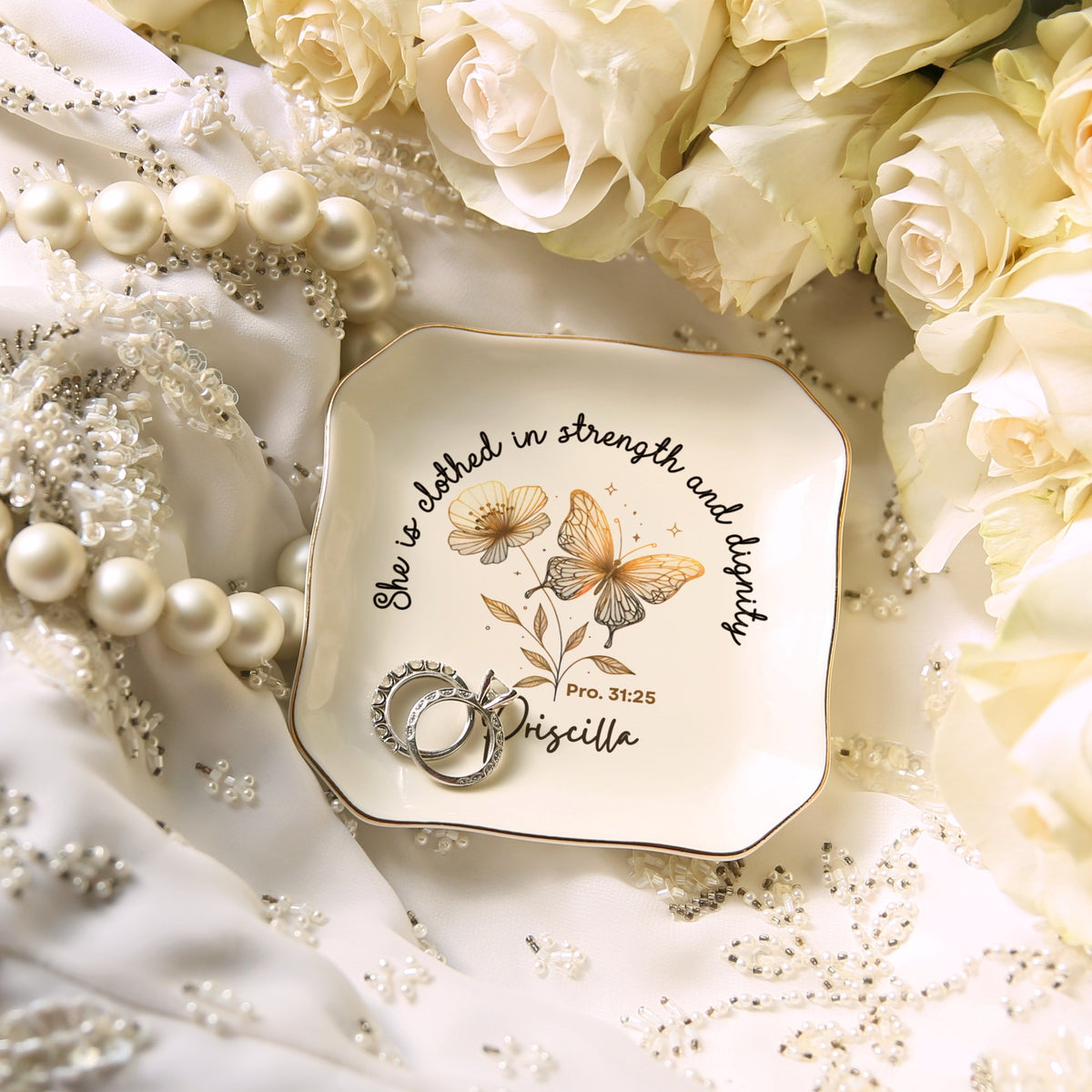 Personalized wavy square ring dish with the name Priscilla, holding rings among pearls and roses